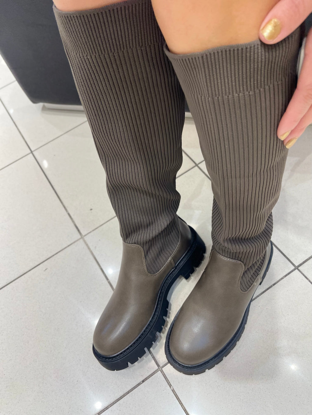 STIEFEL MIT STRICK-DETAIL IN SCHLAMM